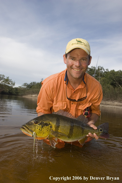 Fisherman holding Peacock Bass