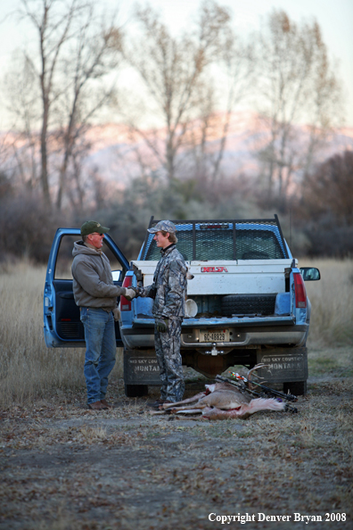 Bowhunter bagging Whitetail Deer