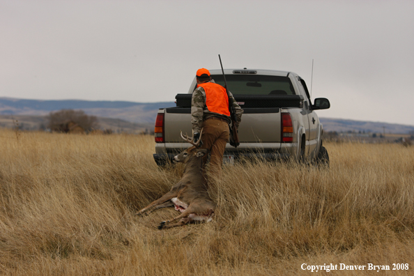 Hunter with Whitetail Deer