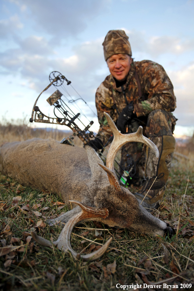 Bowhunter with whitetail buck.