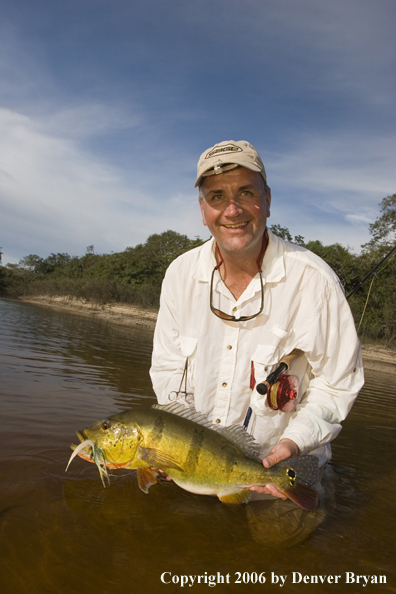Fisherman holding Peacock Bass