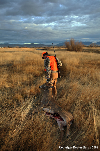 Hunter with Whitetail Deer
