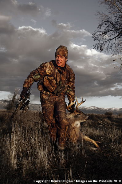 Bowhunter dragging bagged whitetail deer. (Original image # 11049-017.29D)