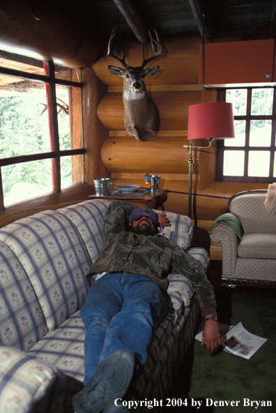 Big game hunter in cabin.