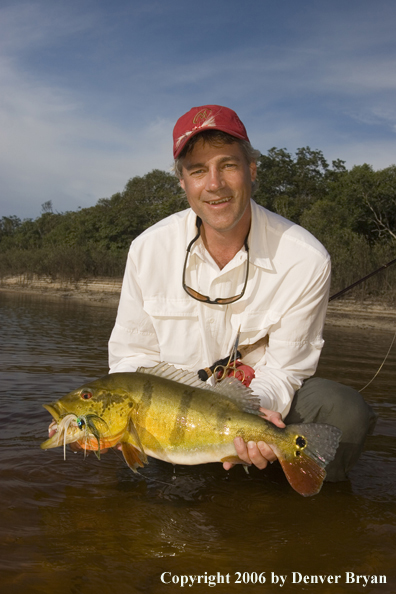 Fisherman holding Peacock Bass
