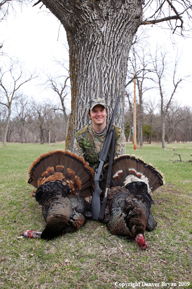 Young hunter with bagged Merriam's turkeys