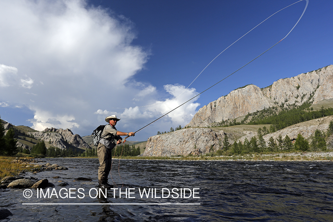 Flyfisherman casting spey/switch with taimen fly.
