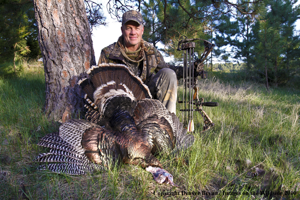 Hunter with bagged (Merriam's) turkey