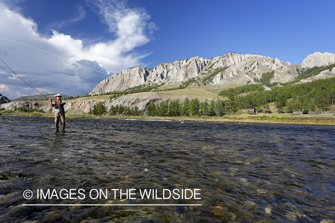 Flyfisherman casting spey/switch with taimen fly.