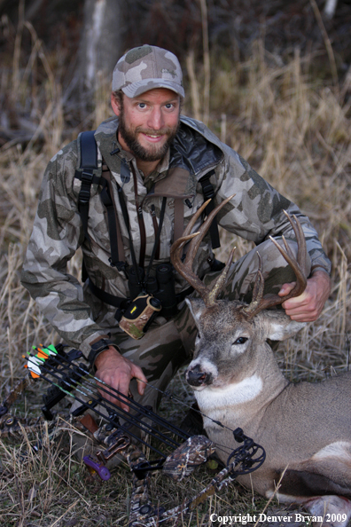 Bowhunter with bagged whitetail buck.