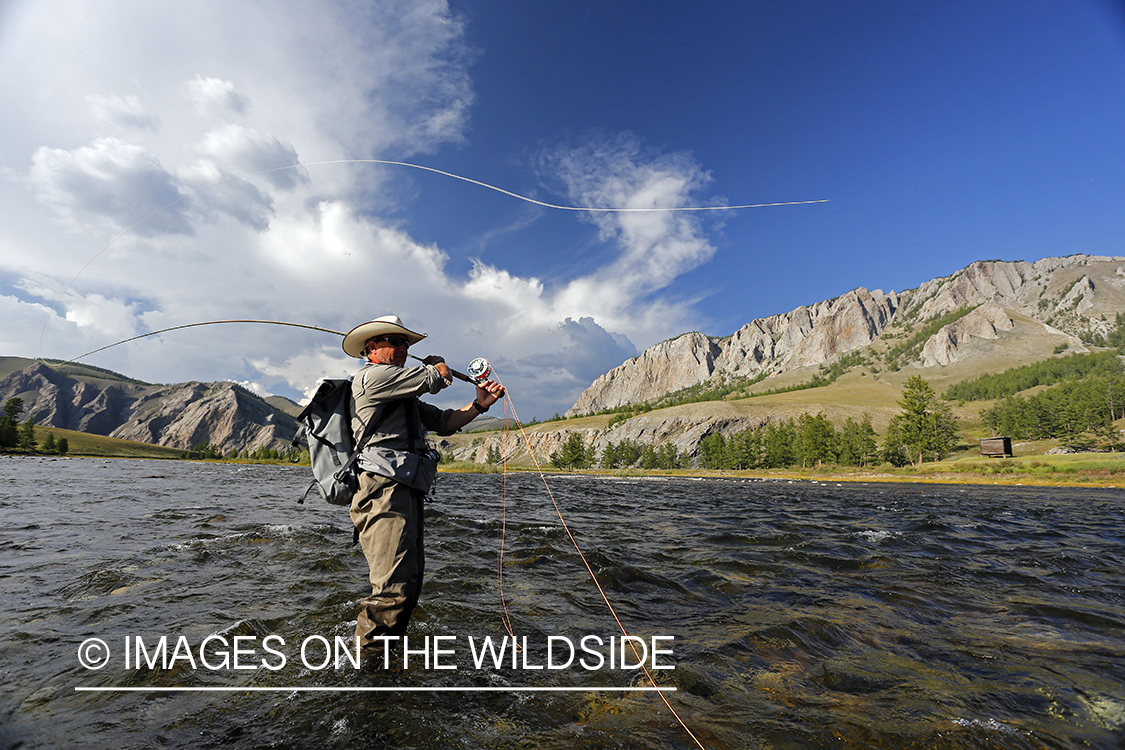 Flyfisherman casting spey/switch with taimen fly.