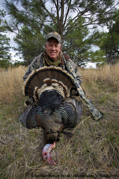 Hunter with bagged (Merriam's) turkey