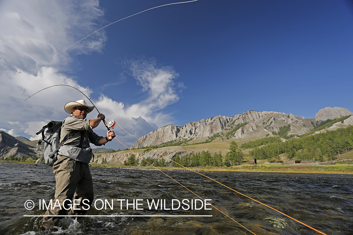 Flyfisherman casting spey/switch with taimen fly.