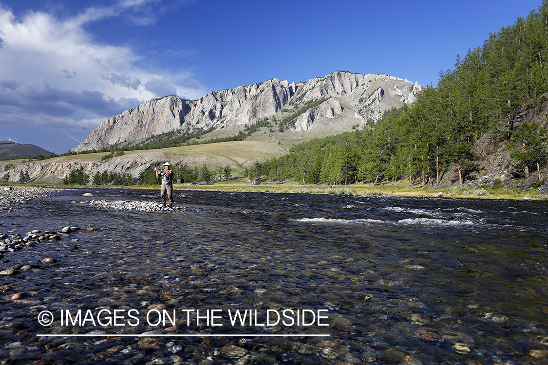 Flyfisherman casting spey/switch with taimen fly.