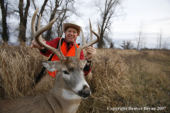 Hunter in field with bagged deer