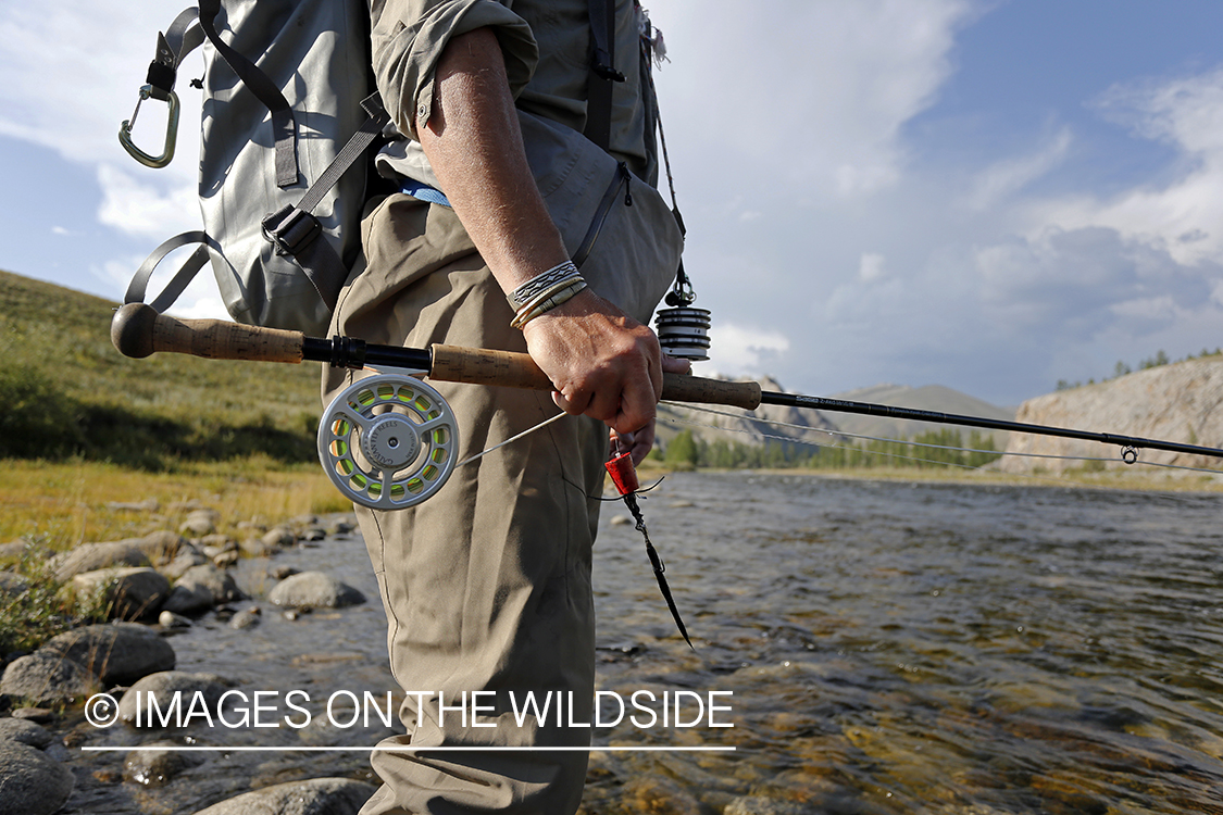 Flyfisherman with spey/switch fly rod and taimen fly.