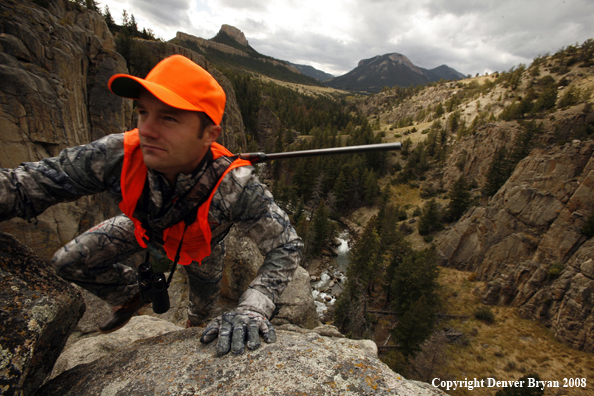 Rifle Hunter Climbing Cliffs