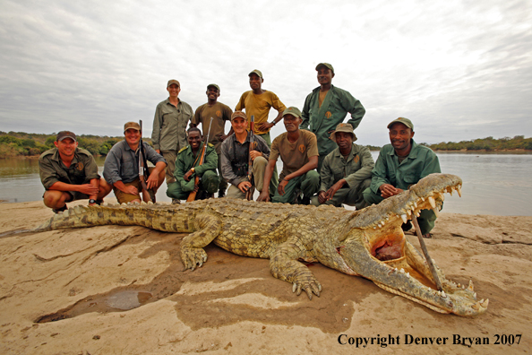 Hunters and guides with bagged African crocodile