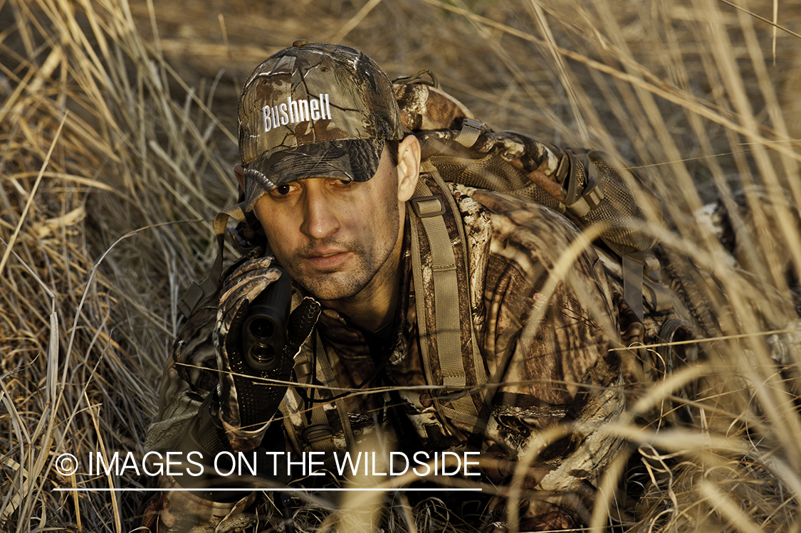 Bowhunter using rangefinder. 