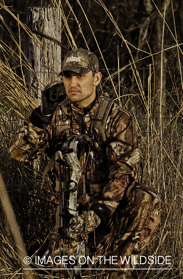 Bowhunter using rangefinder. 