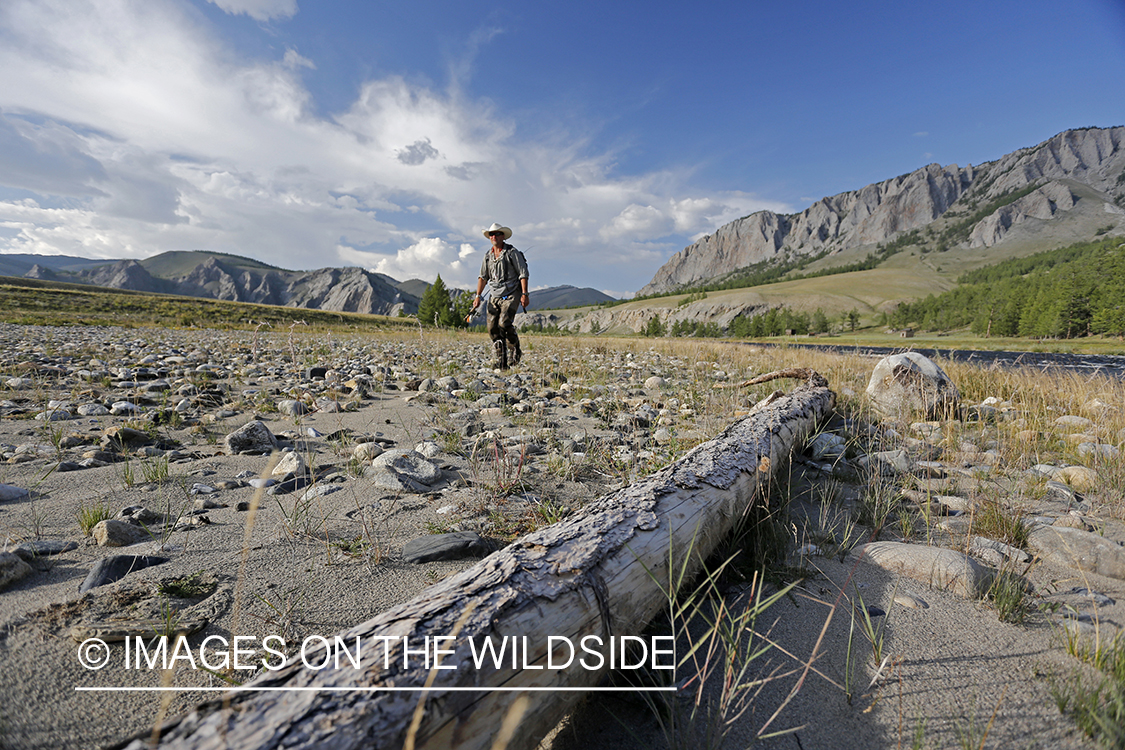 Flyfisherman walking along Delger River, Mongolia.