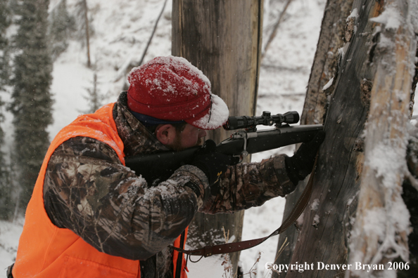 Big Game hunter aiming. Winter.