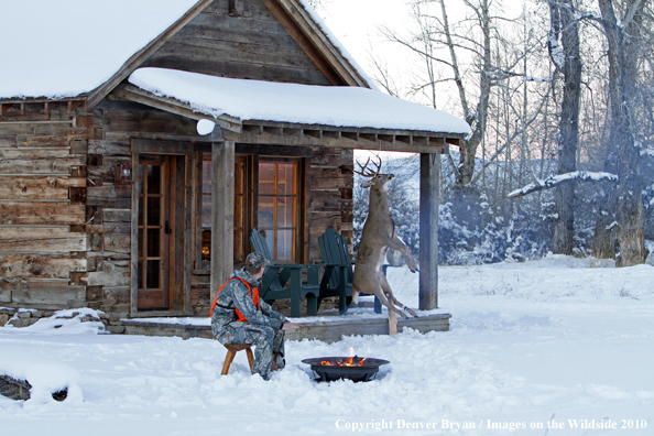 White-tailed deer hunter warming hands by campfire.