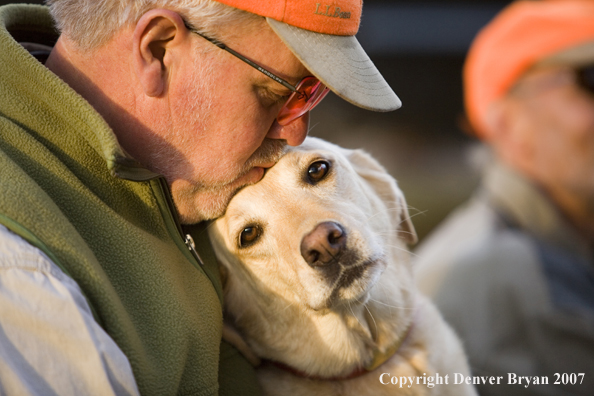 Upland game bird hunter with yellow labrador retriever