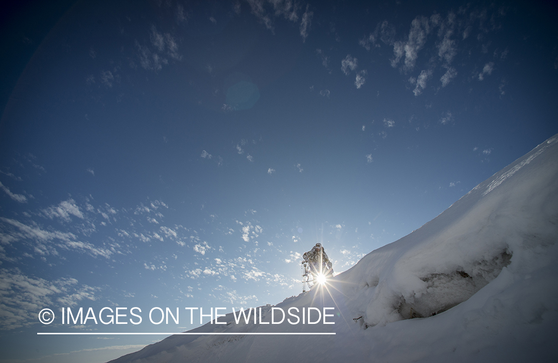 Bowhunter in winter landscape.