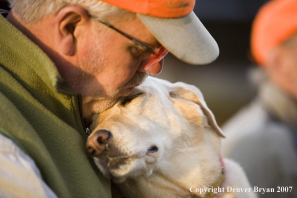 Upland game bird hunter with yellow labrador retriever