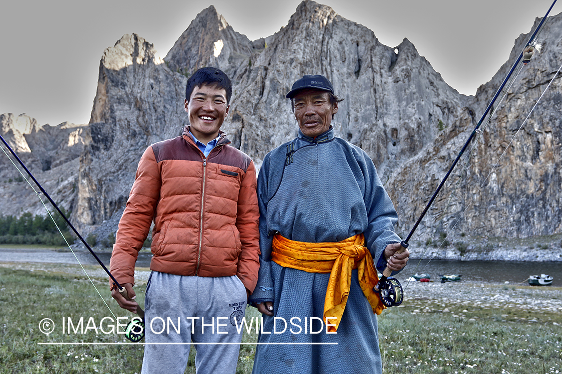 Young and elder mongolian men with flyfishing rods.