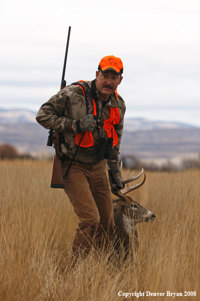 Hunter with Whitetail Deer