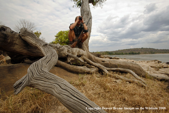 Hunter scouting area for crocodiles