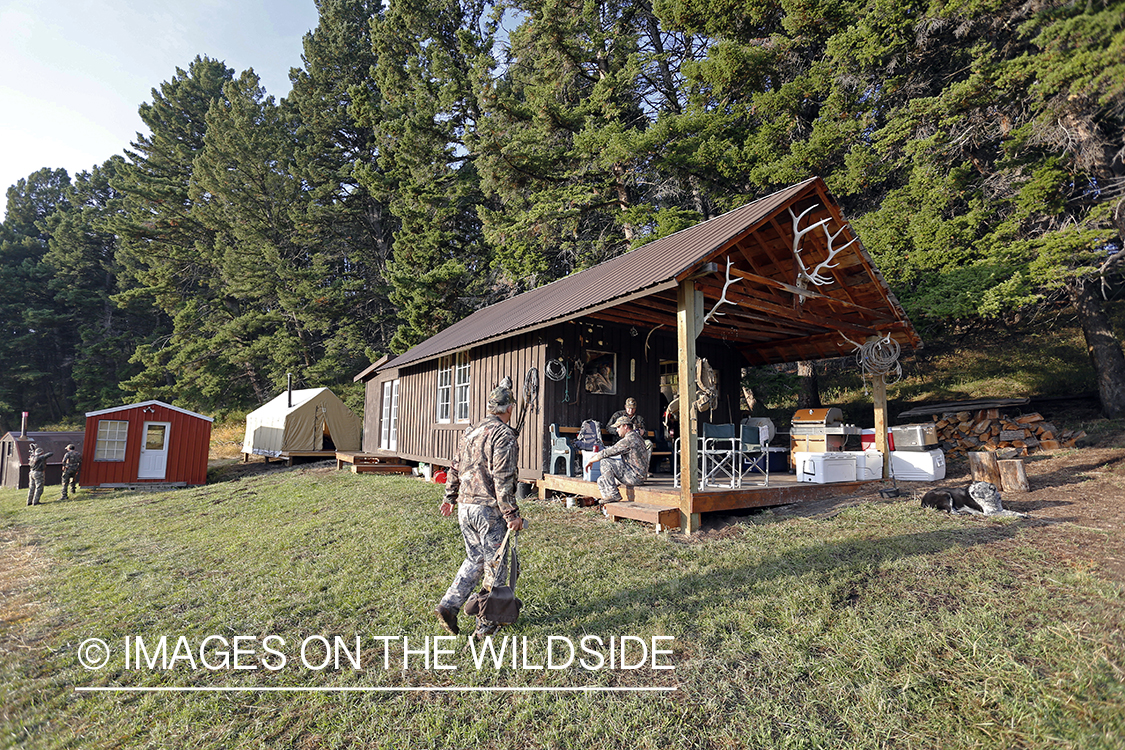 Bowhunters relaxing at elk hunting campsite.