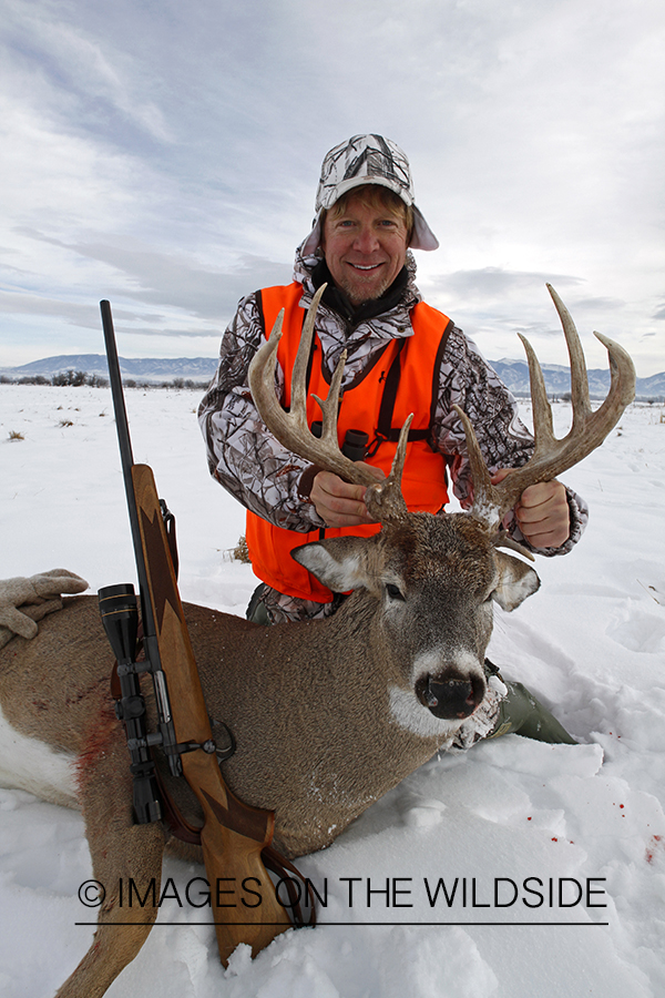 Hunter with bagged white-tailed deer.