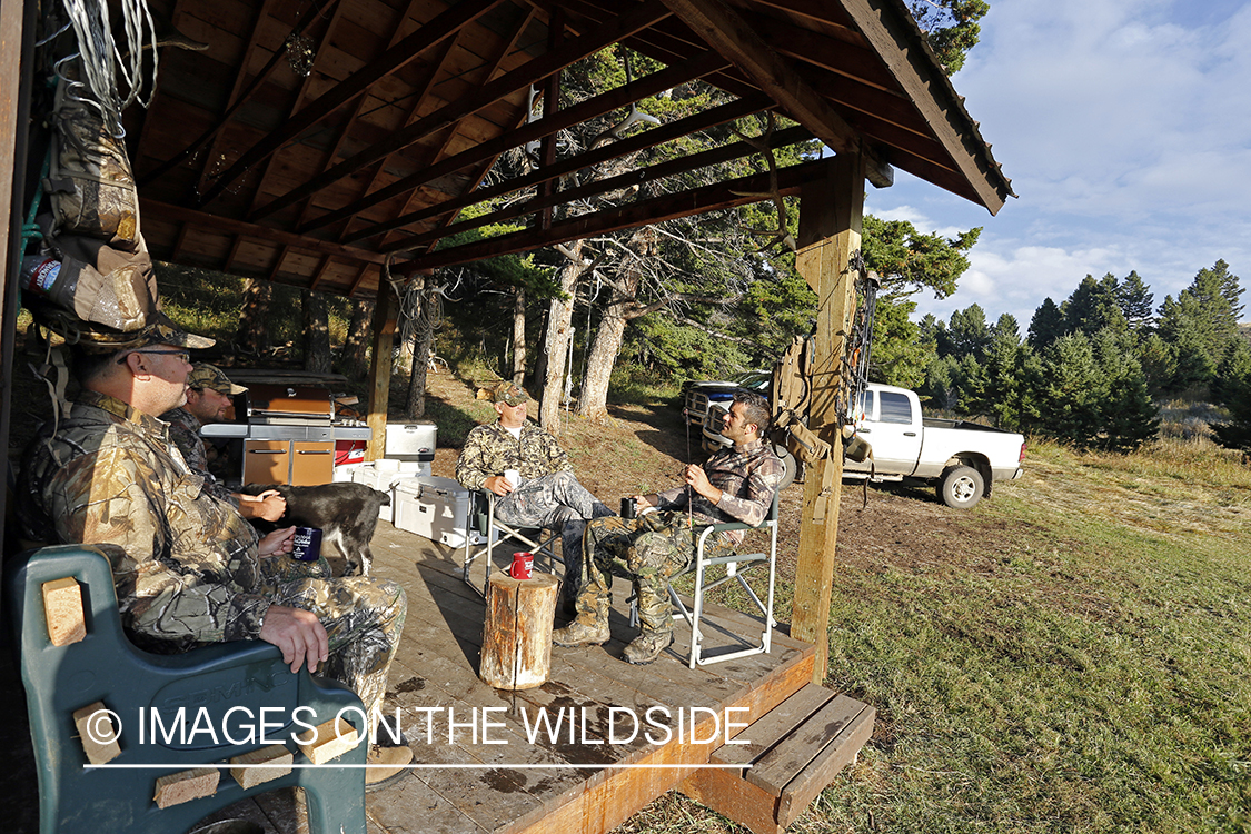 Bowhunters relaxing at elk hunting campsite.
