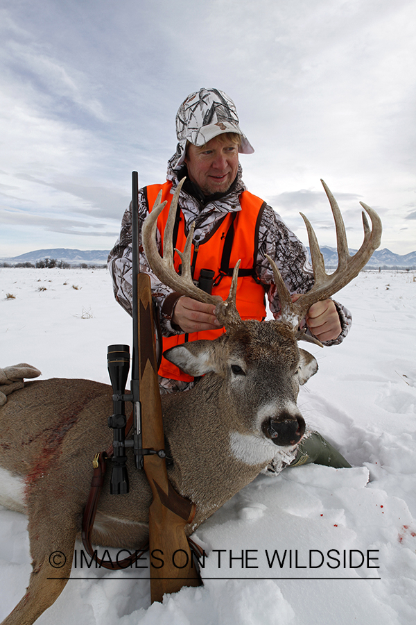 Hunter with bagged white-tailed deer.