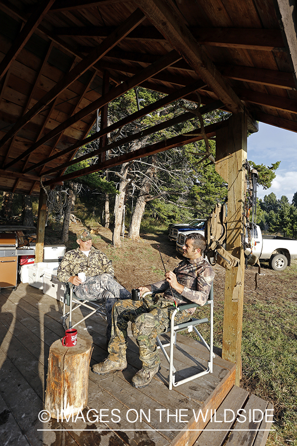Bowhunters relaxing at elk hunting campsite.