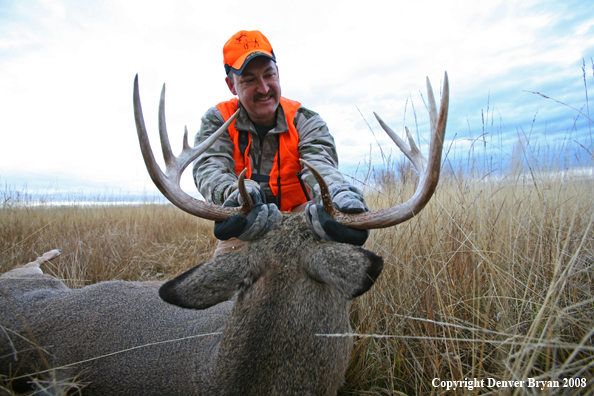 Hunter with Whitetail Deer