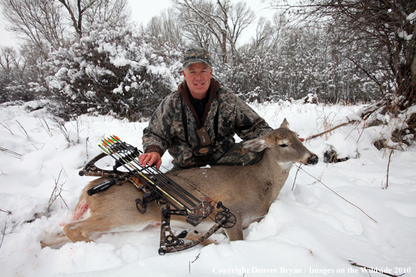 Archery hunter with bagged white-tailed doe. 