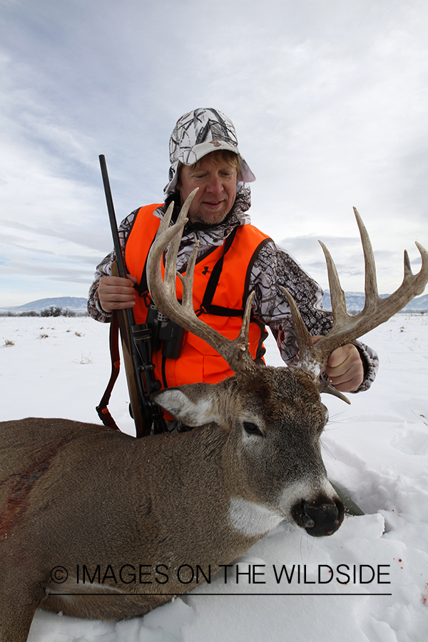 Hunter with bagged white-tailed deer.