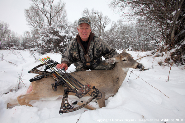 Archery hunter with bagged white-tailed doe. 