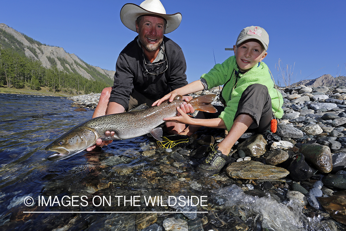 Mark and Cooper Johnstad releasing taimen.
