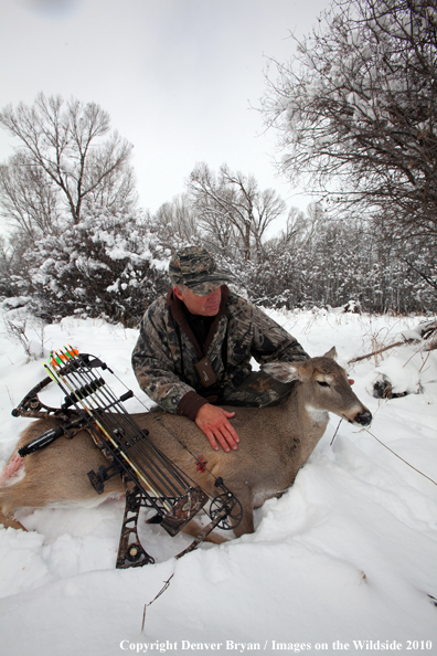 Archery hunter with bagged white-tailed doe. 