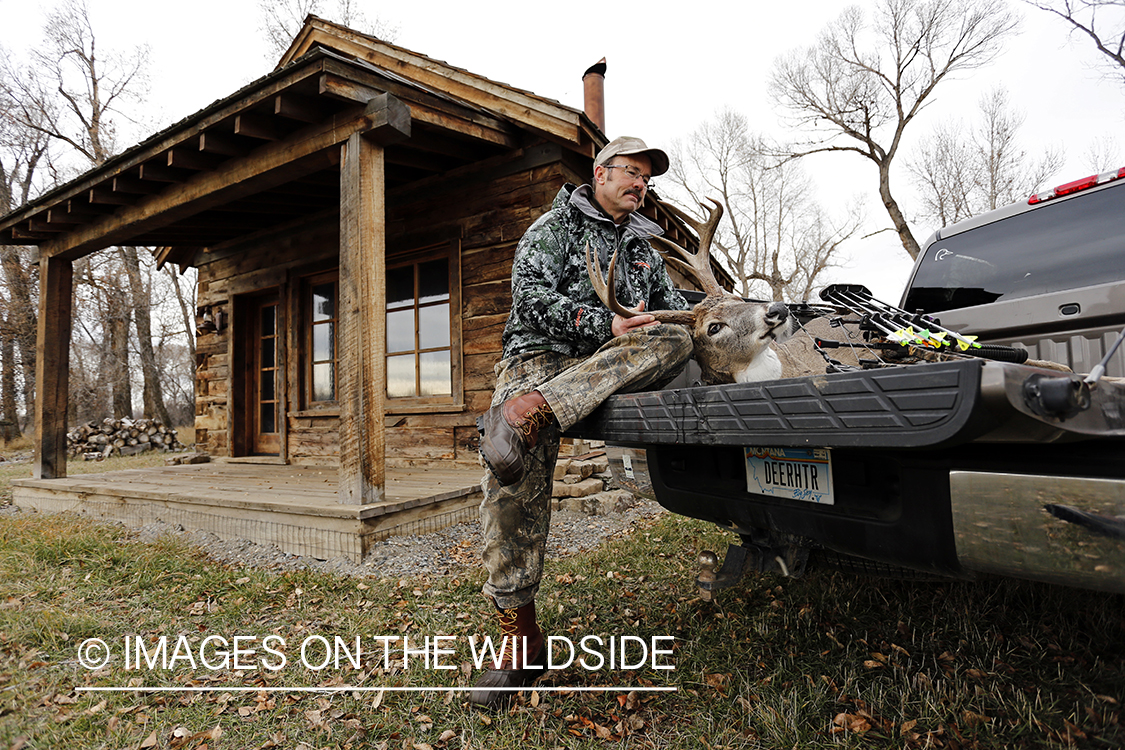 Bowhunter with bagged white-tailed buck.