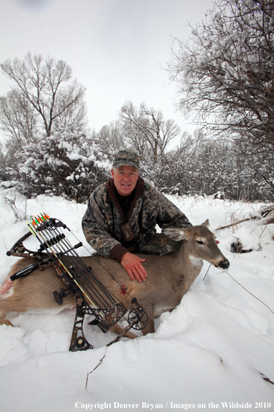 Archery hunter with bagged white-tailed doe. 