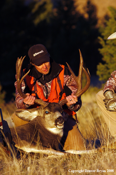 Hunter with Mule Deer