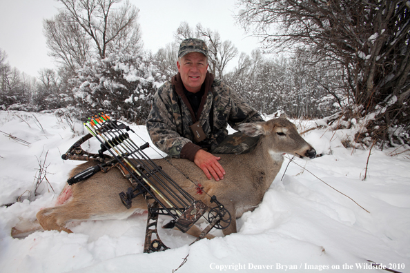 Archery hunter with bagged white-tailed doe. 