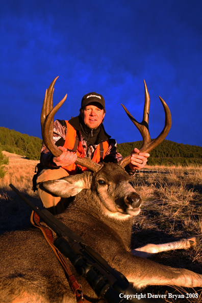 Hunter with Mule Deer