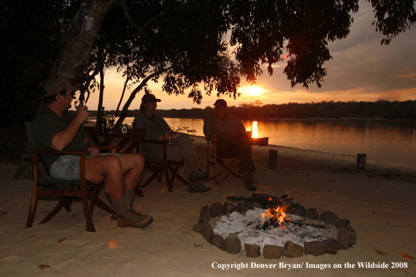 Hunters sitting around fire